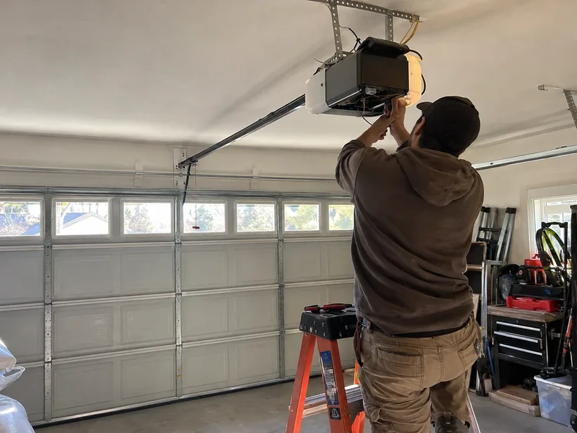 Technician servicing a residential garage door opener