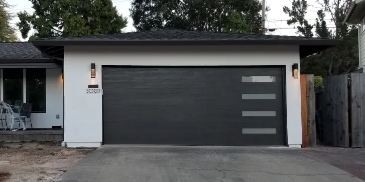 Steel carriage-style garage door with arched windows